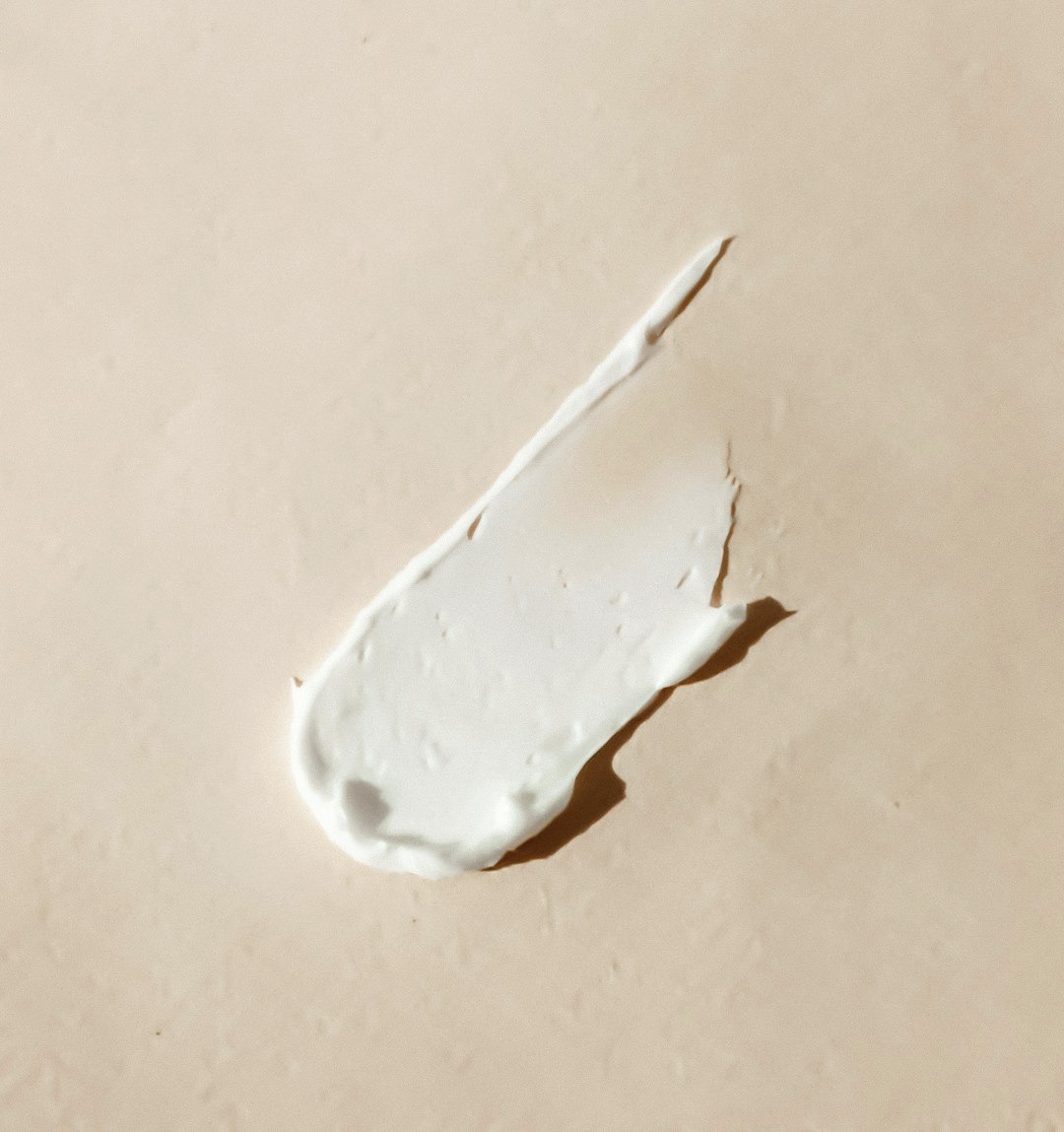 white cream smear on beige surface